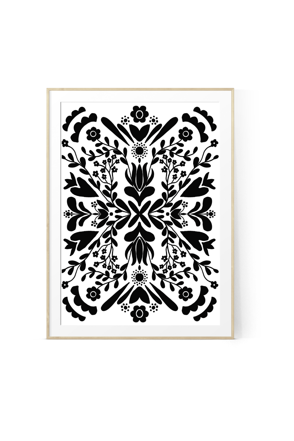 Black and white floral botanical wall art print featuring symmetrical flowers, leaves, vines and folk-inspired botanical details