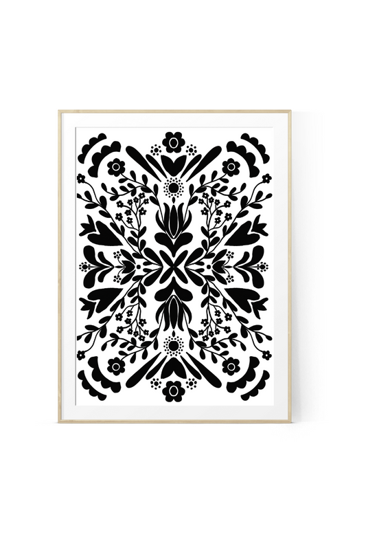 Black and white floral botanical wall art print featuring symmetrical flowers, leaves, vines and folk-inspired botanical details