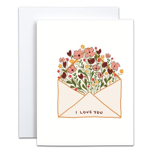 A white greeting card with a floral envelope illustration and the words 'I LOVE YOU' printed on the front, shown with a white envelope behind it on a light gray background.